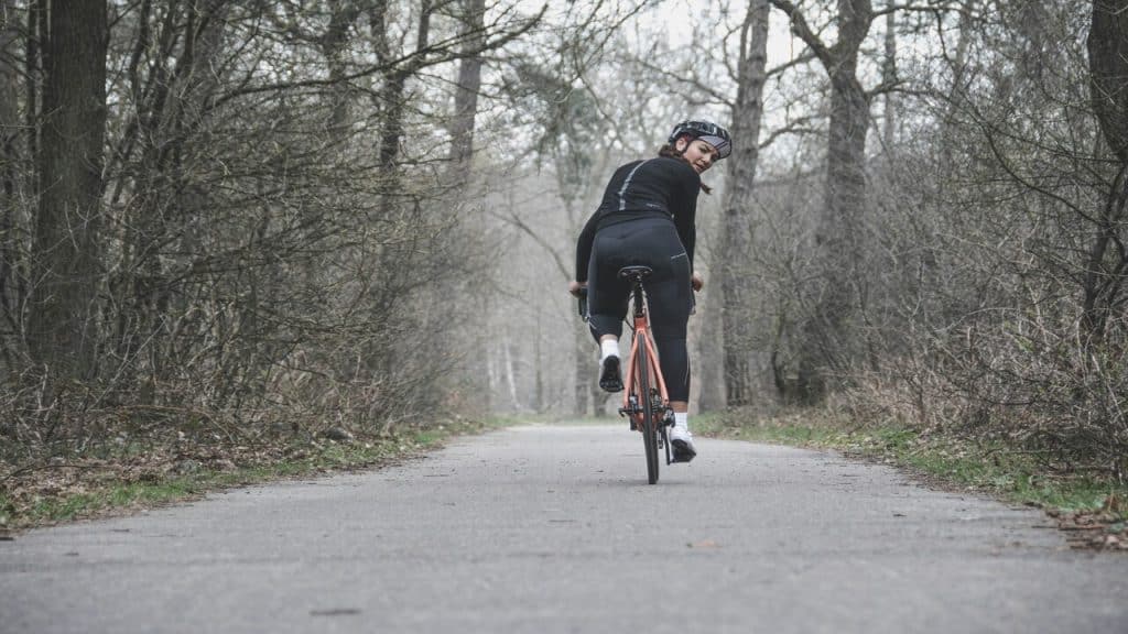A woman biking by herself