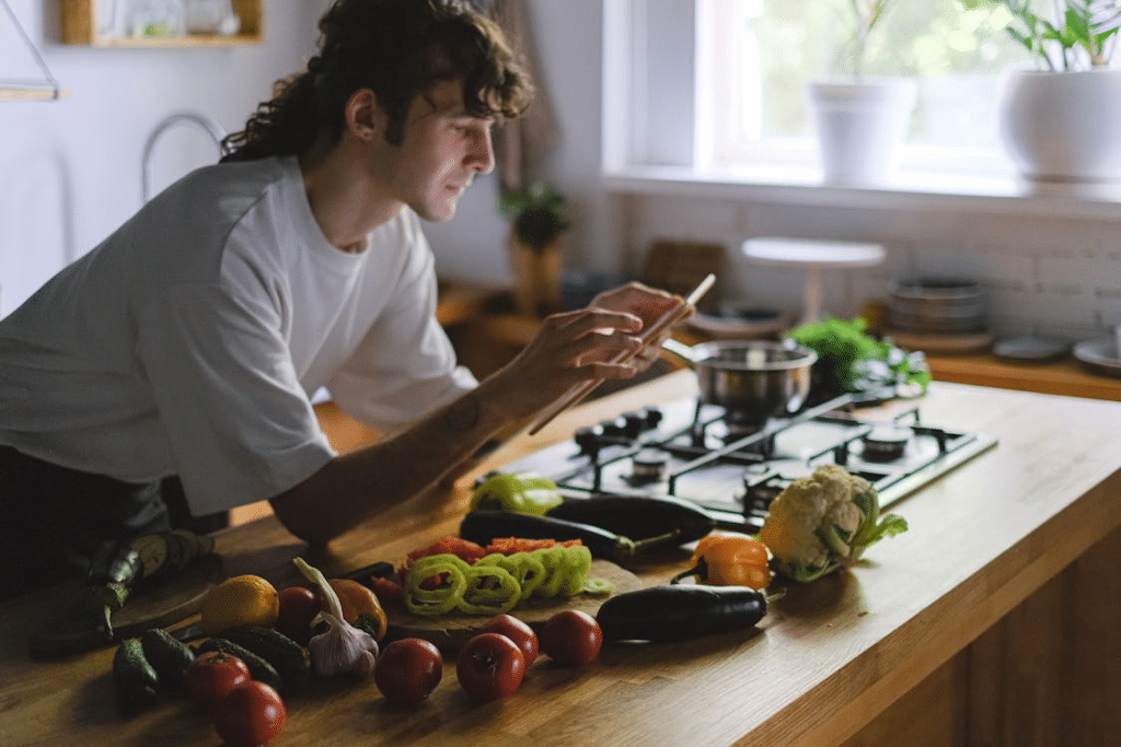 Young Chef Photographing Fresh Ingredients in Kitchen