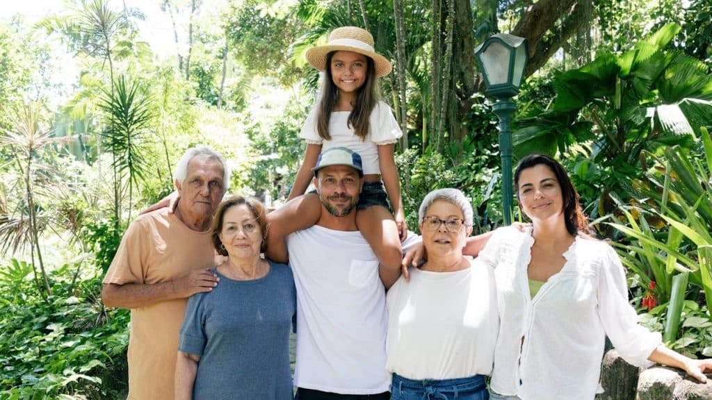 A family posing together for a photo in the woods.