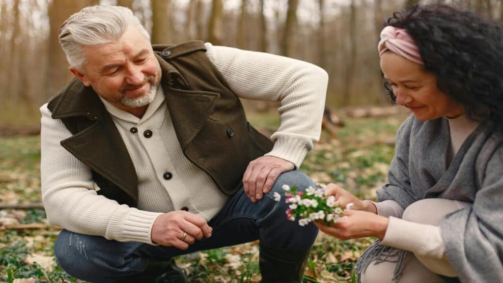 A couple picking up flowers