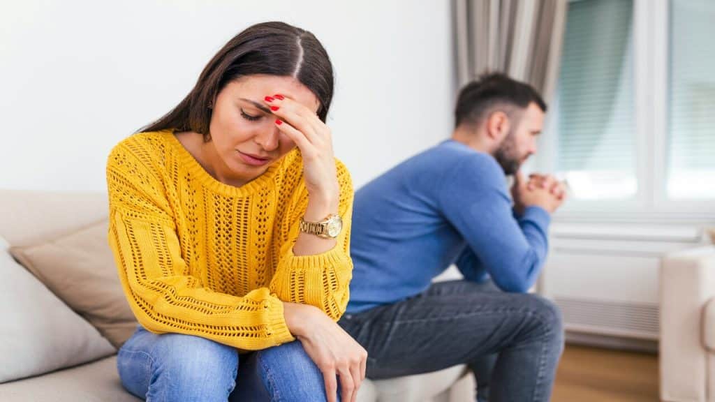 A woman looking disappointed in her husband