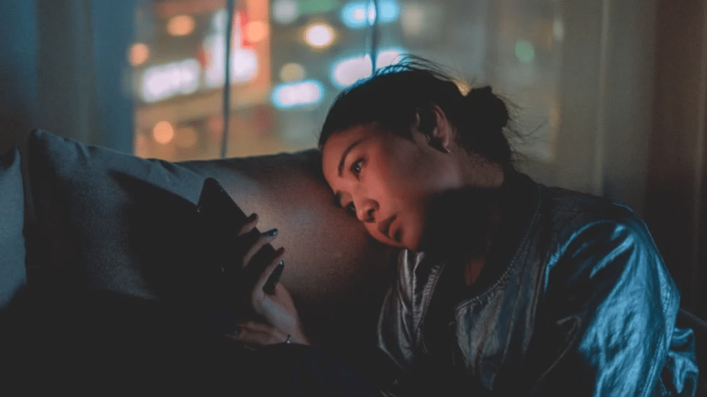 A woman looking sad while texting