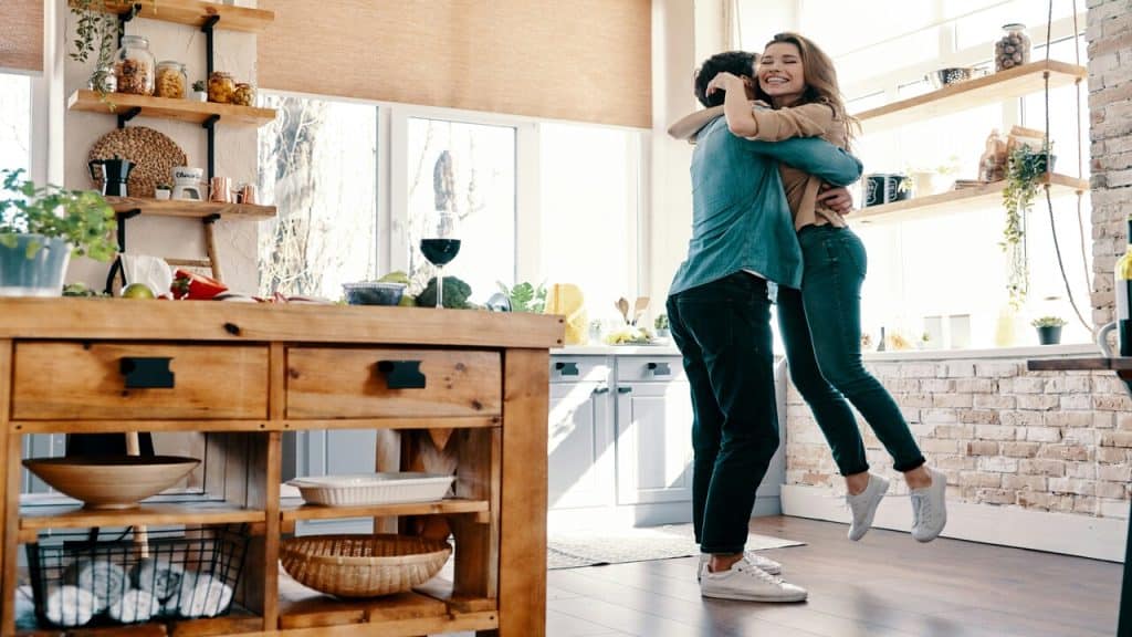 A couple hugging in the kitchen