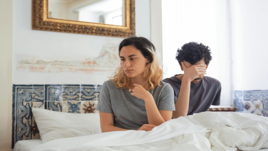 A couple ignoring each other in bed