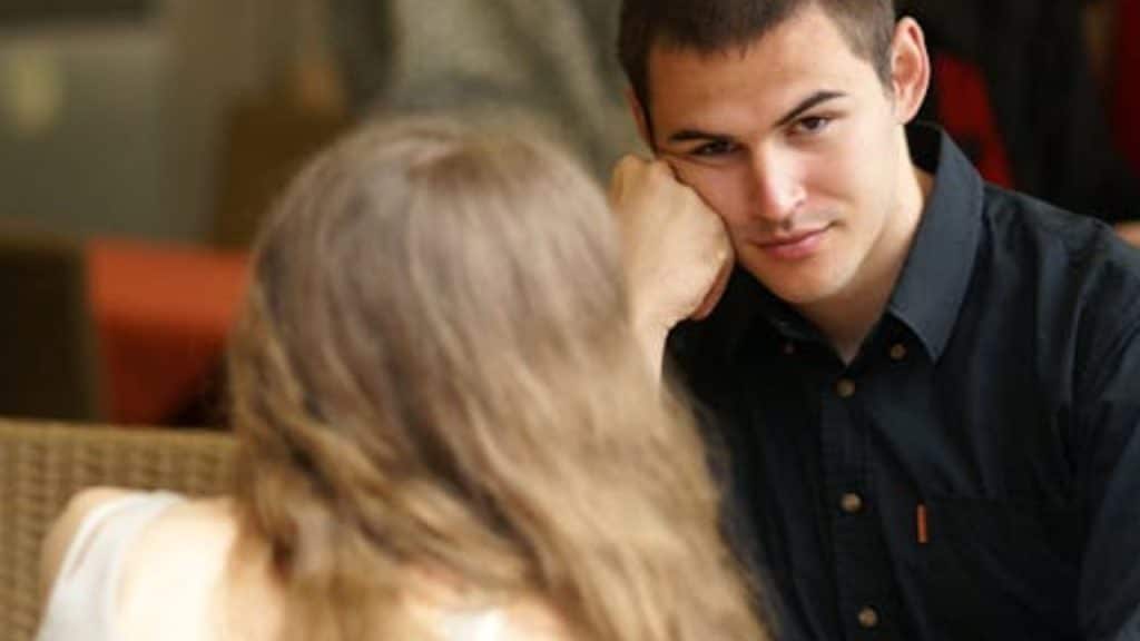 Couple showing emotional disinterest during dinner conversation