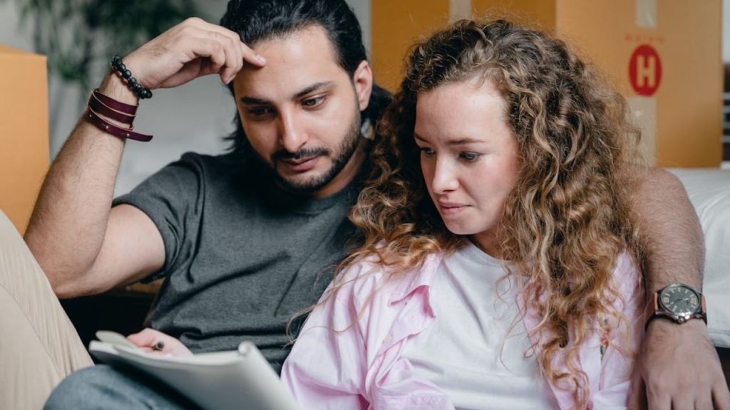 A couple planning their week with a notebook