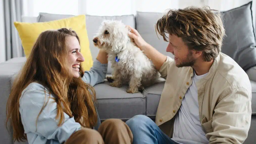 A happy young couple with their dog.