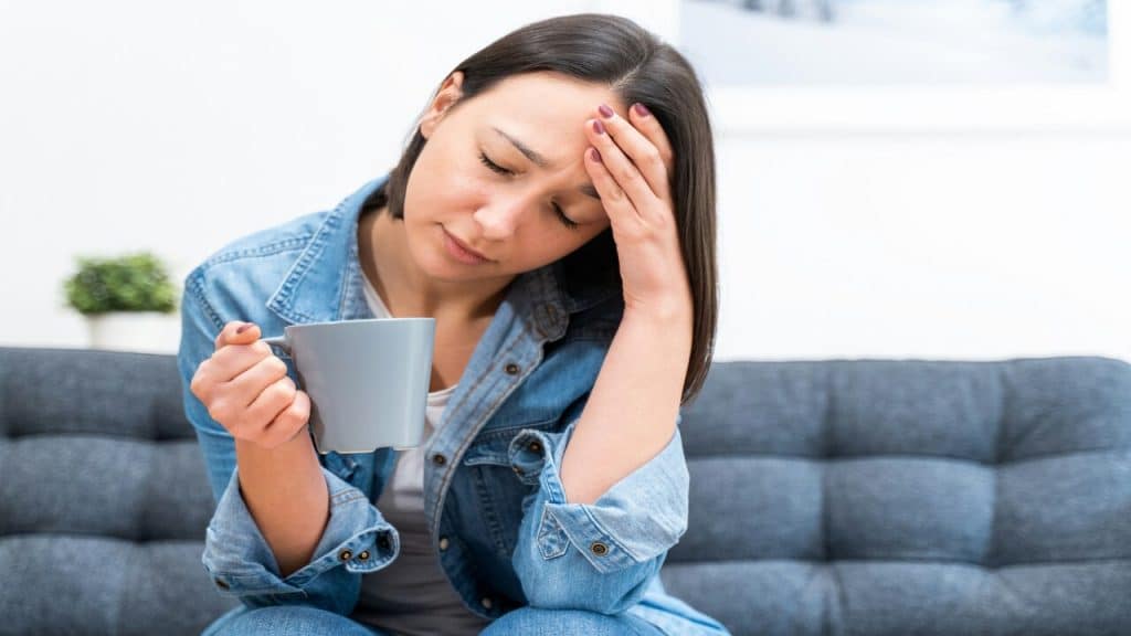 A woman looking tired at home