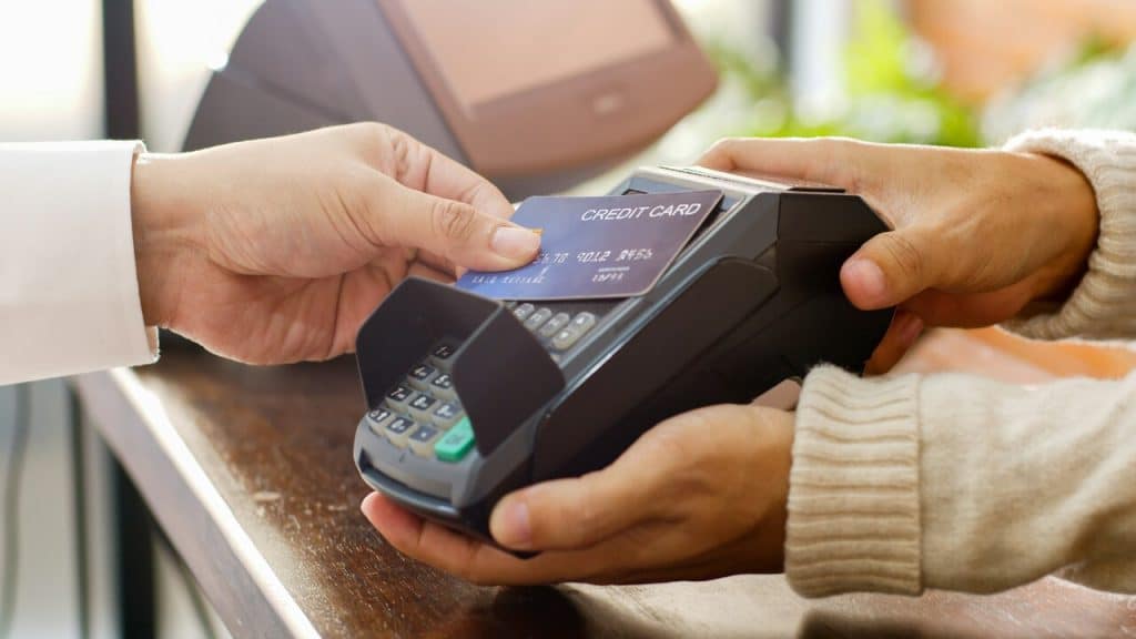 A person paying using their credit card