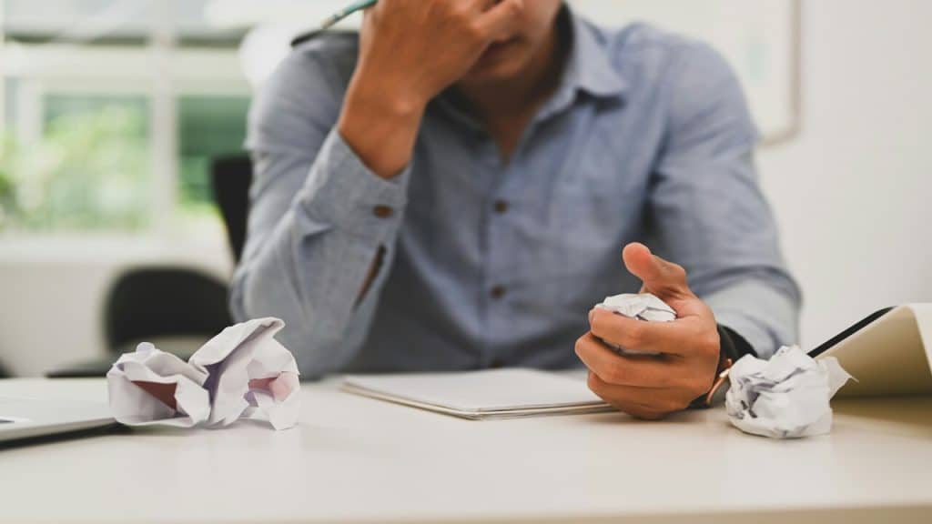 A man stressed over rejected project proposal