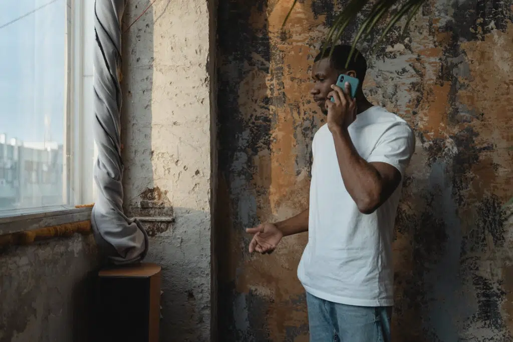 Man in White Crew Neck T-shirt Having a Phone Call