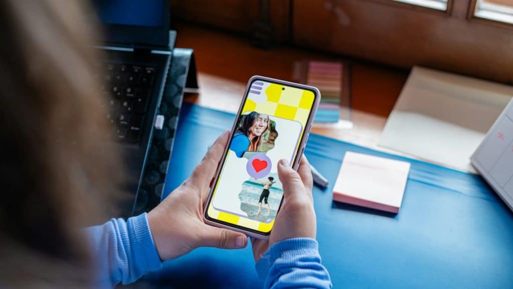 A person holding a smartphone and viewing a dating app.