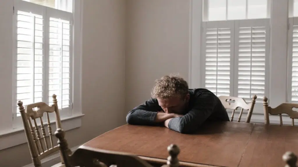 A man looking sad at home