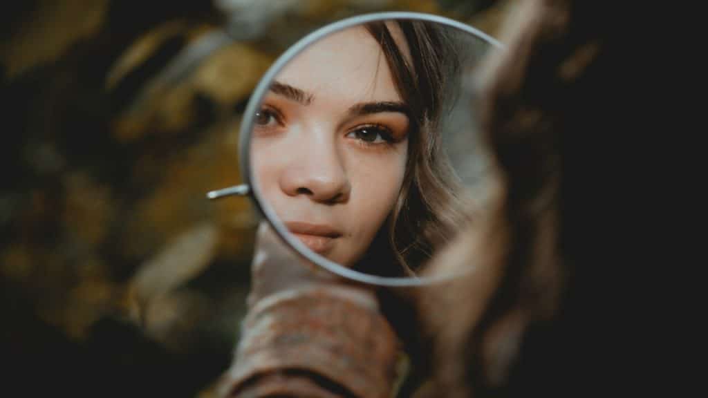 A woman looking at herself in the mirror