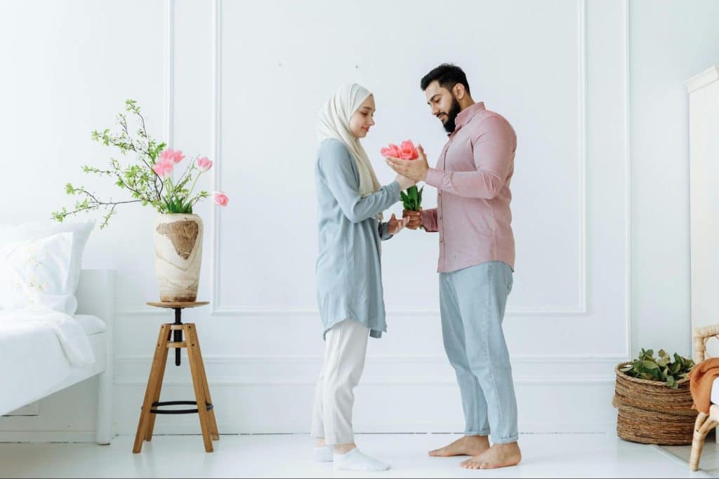 A man giving a flower to woman