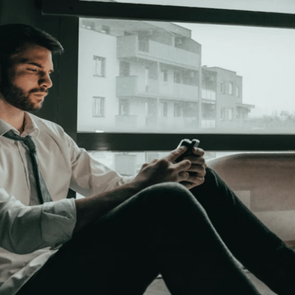 A man looking sad while texting