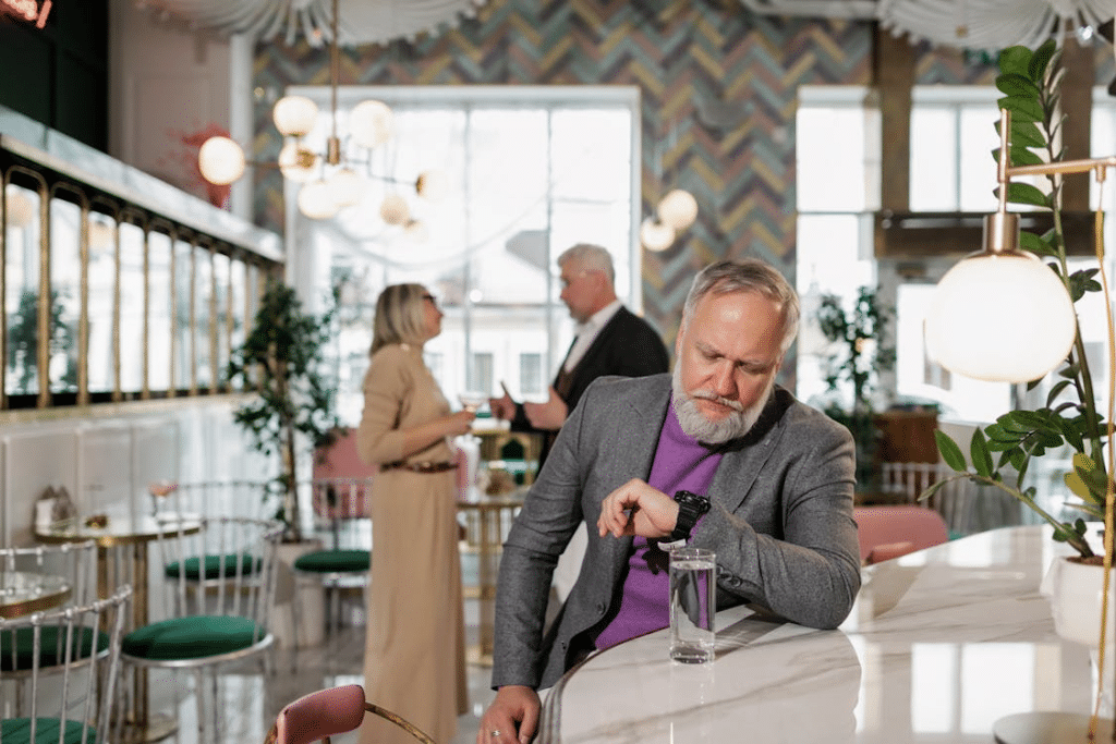 Man in Gray Suit Jacket Looking at his Watch