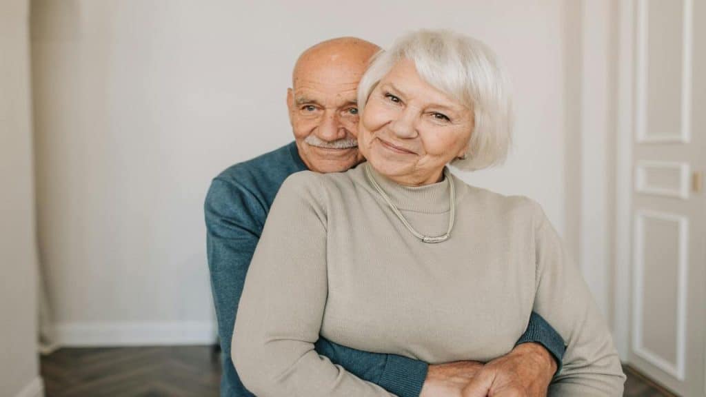 A mature couple hugging at home
