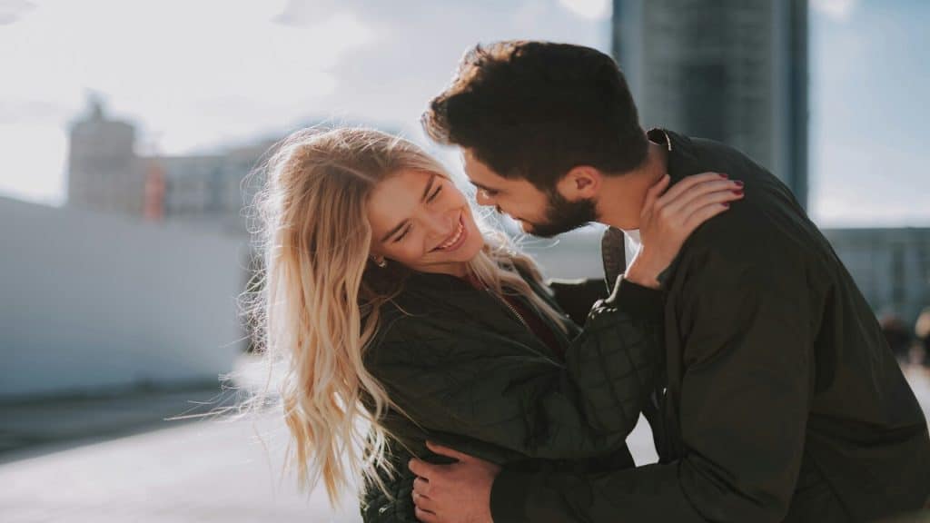 A couple hugging outdoors