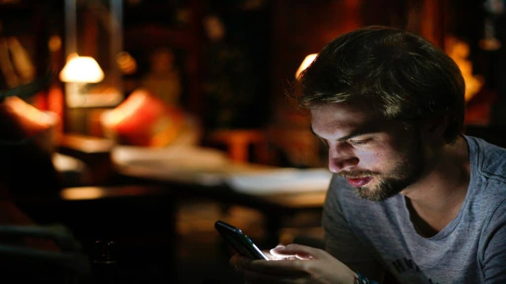 A man texting at night 