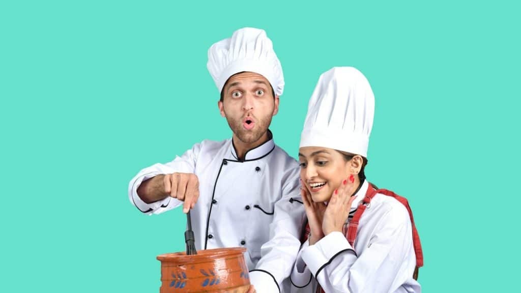 A couple cooking something together.