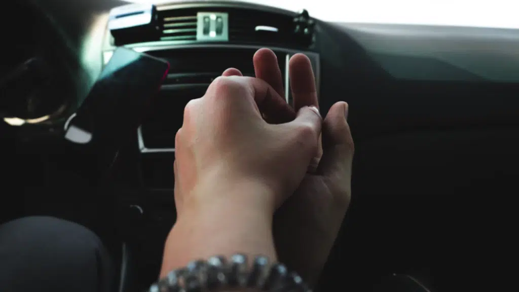 A couple holding hands in the car