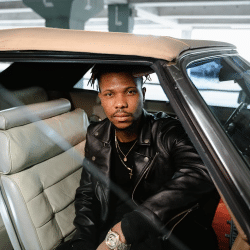 Man in Black Leather Jacket Sitting Inside Car