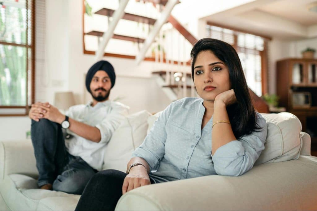 A man and woman sitting at the couch