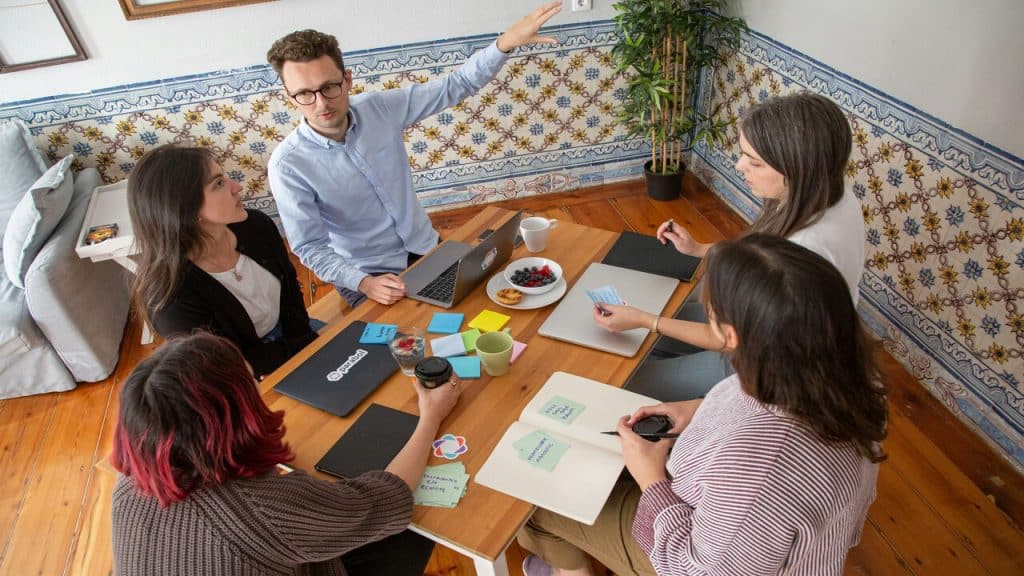 A man leading a team meeting