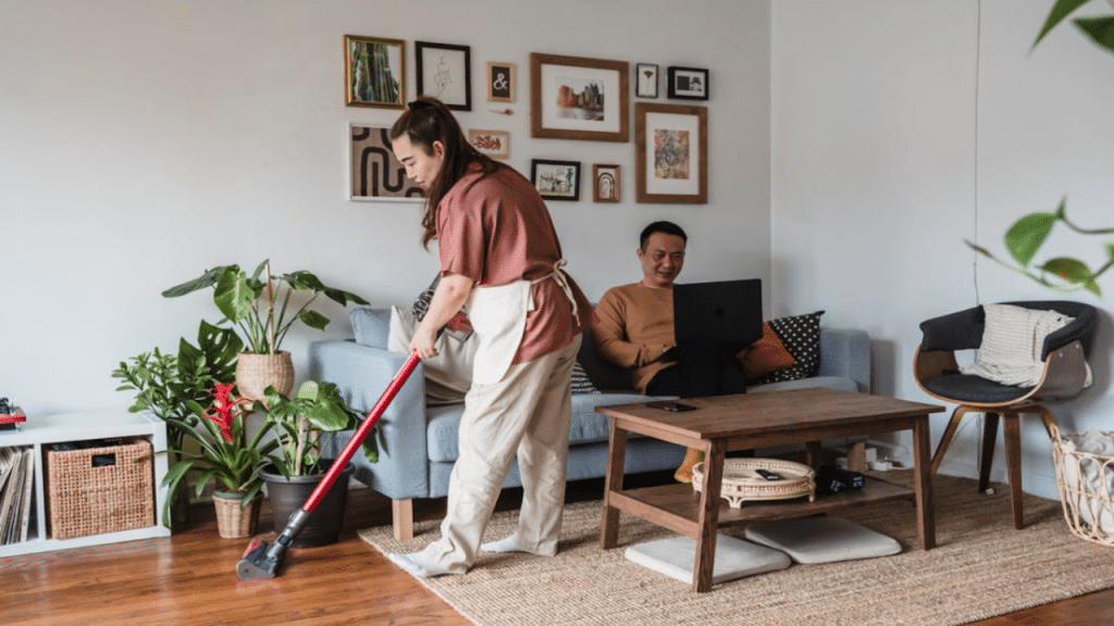 A man ignoring his cleaning wife