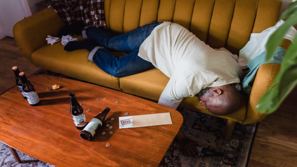 A man passed out on the couch due to drinking