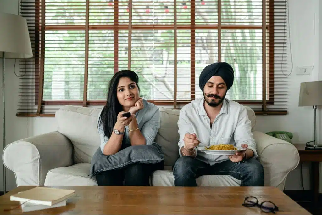A man appreciating the food and a woman does not care