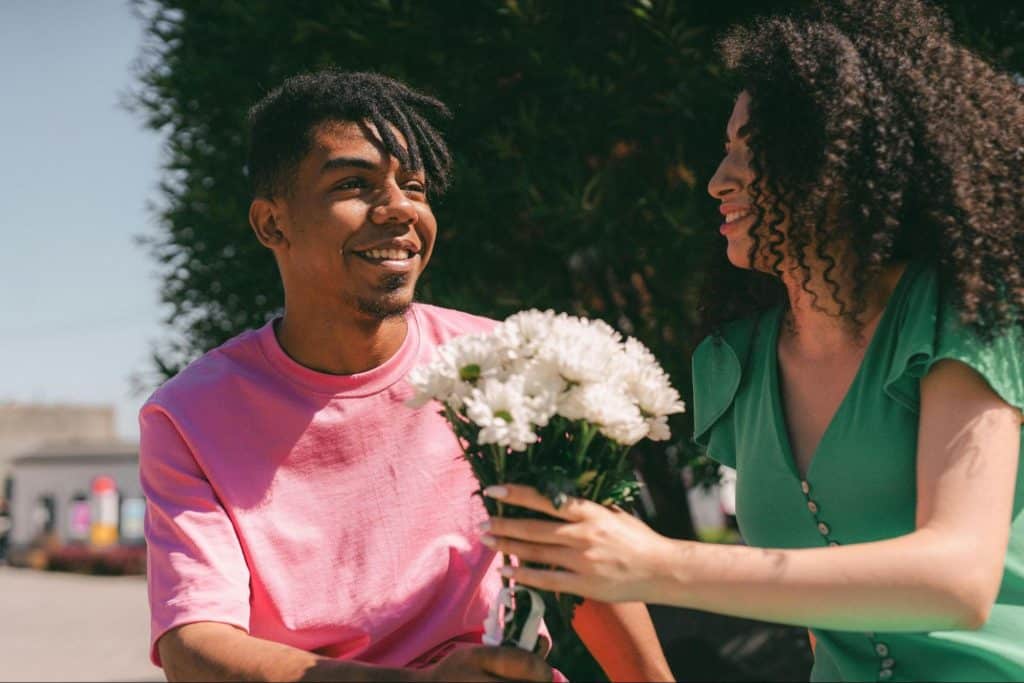 A man giving a woman a flower