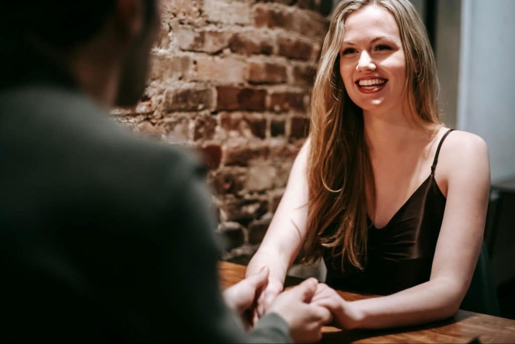 A woman looking at the man