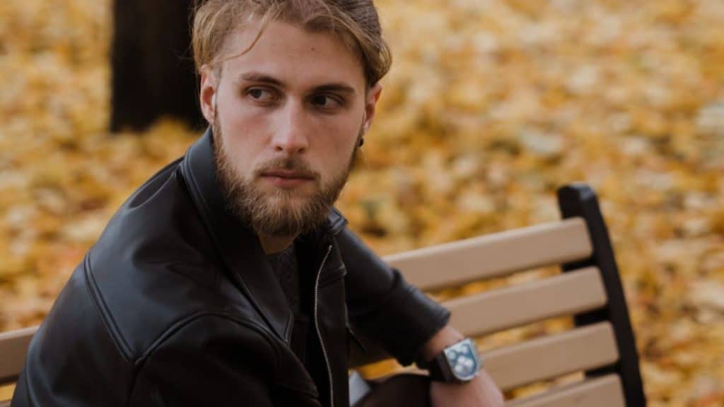 Man contemplating his relationship while sitting alone in a park