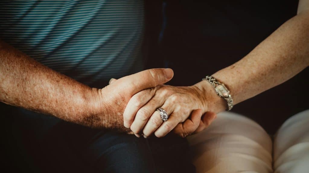 A couple holding hands.