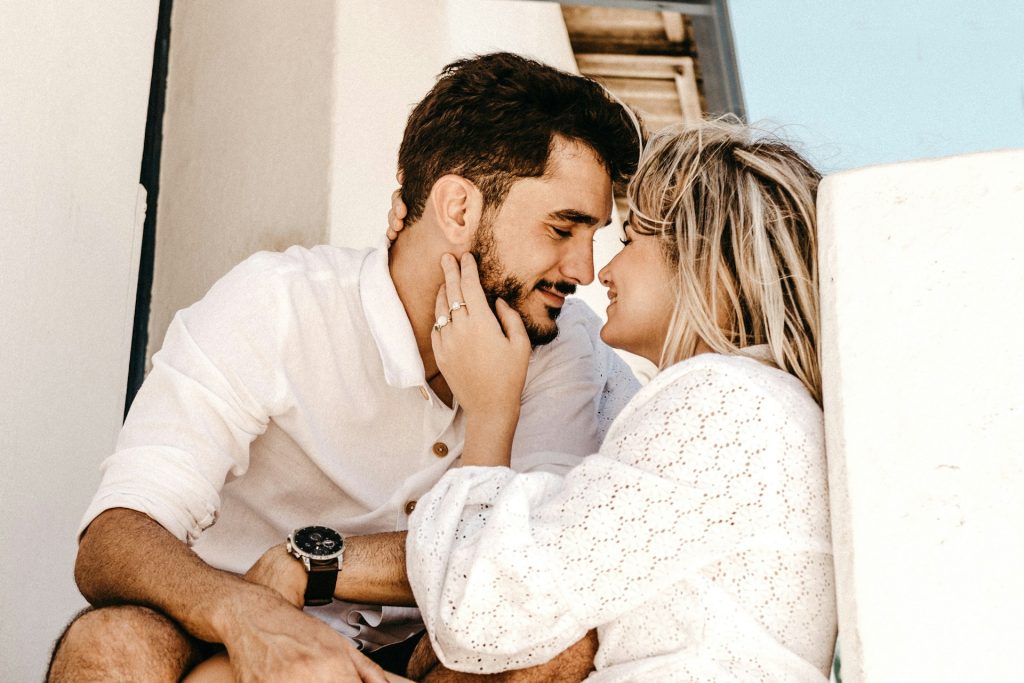 The woman is looking lovingly at the man.