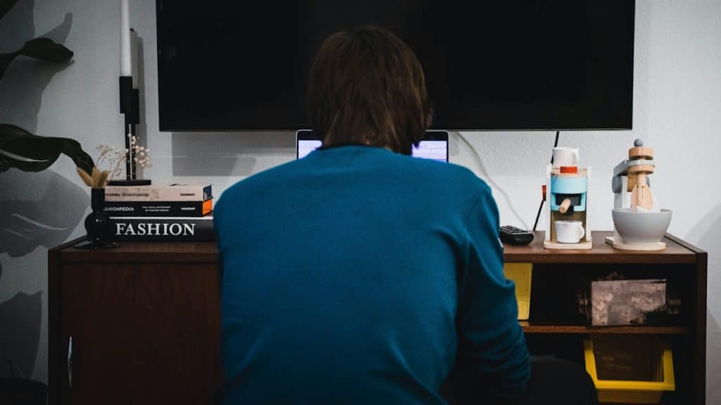 A person sitting at a desk working on a laptop.