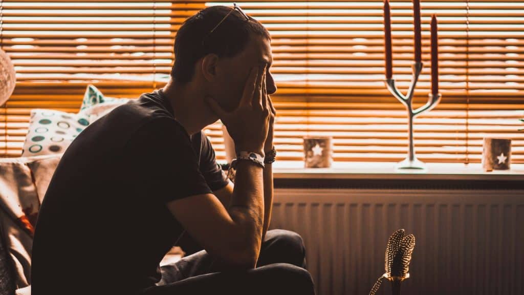 A man looking sad at home