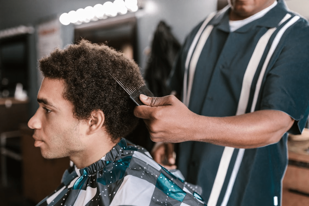 A Barber Combing a Man's Hair