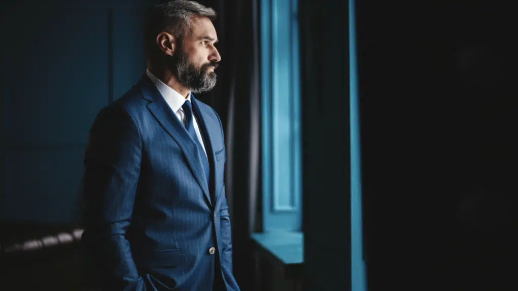 A mature man looking out the window