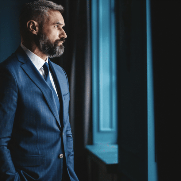 A mature man looking out the window