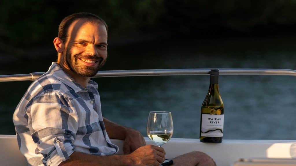 A man having wine on a boat