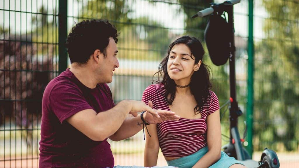 A young couple sitting in a park