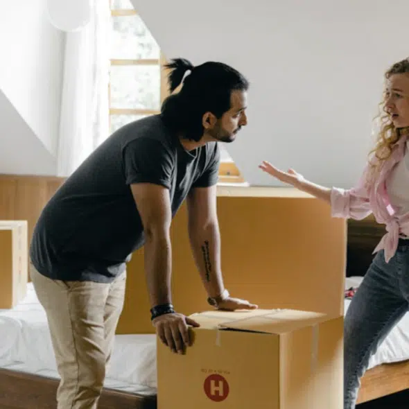 A couple arguing while moving