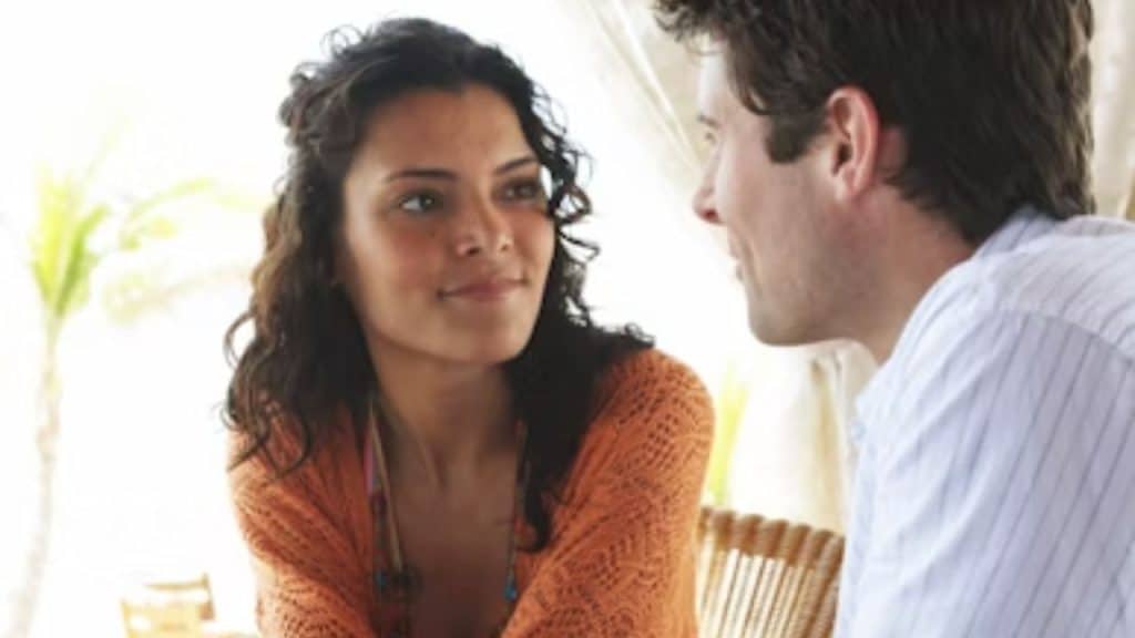 Couple sitting close together, having an open heart to heart talk