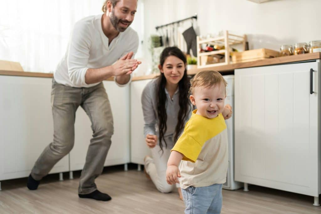 The couple is teaching their son to walk.