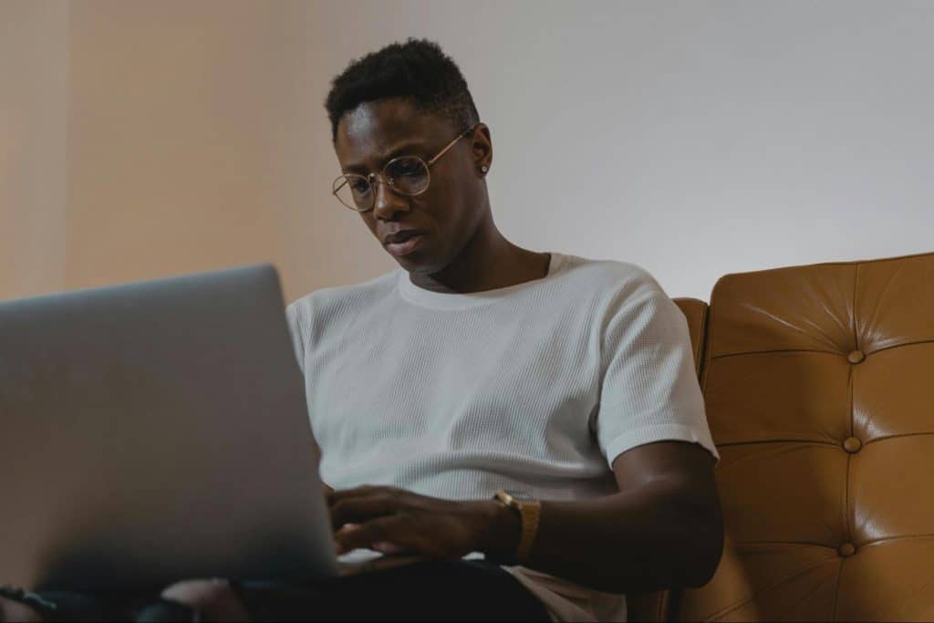 A man looking serious while using laptop