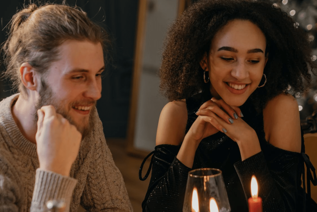 Couple Sitting on Table with Candle Lights