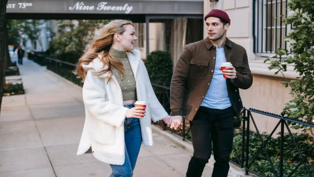 A couple walking on a sidewalk